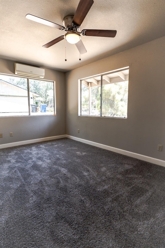 42560 Ranger Circle Way, Coarsegold, CA 93614 - empty room with a wall mounted air conditioner, ceiling fan, dark colored carpet, and a textured ceiling