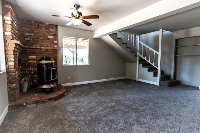 42560 Ranger Circle Way, Coarsegold, CA 93614 - unfurnished living room featuring a wood stove, stairway, a ceiling fan, and carpet floors