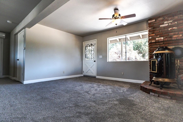 42560 Ranger Circle Way, Coarsegold, CA 93614 - unfurnished living room featuring a wood stove, carpet floors, a ceiling fan, and an AC wall unit