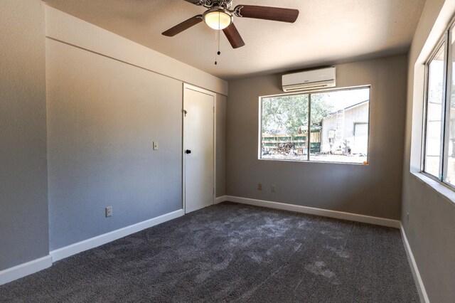 42560 Ranger Circle Way, Coarsegold, CA 93614 - unfurnished bedroom with a wall unit AC, dark colored carpet, multiple windows, and ceiling fan