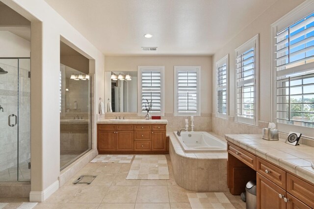 10615 E Landmark Way, Clovis, CA 93619 - bathroom featuring a whirlpool tub, vanity, a shower stall, tile patterned flooring, and recessed lighting