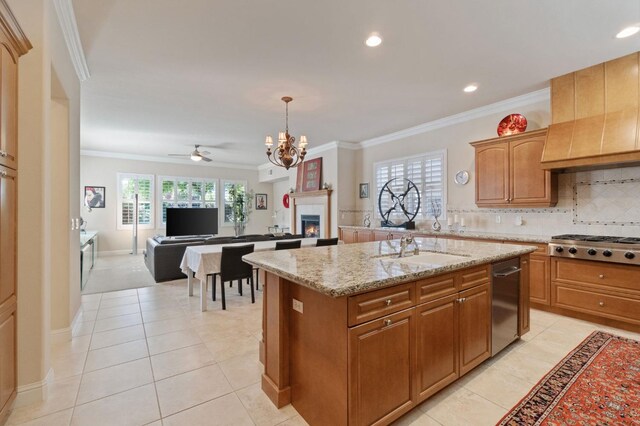 10615 E Landmark Way, Clovis, CA 93619 - kitchen featuring stainless steel appliances, a lit fireplace, crown molding, a center island, and a chandelier
