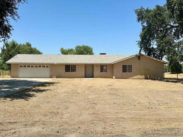13308 Hood Ave, Hanford, CA 93230 - ranch-style home with concrete driveway, an attached garage, and stucco siding