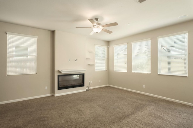 3482 Elevations Way, Clovis, CA 93619 - unfurnished living room with a glass covered fireplace, dark carpet, and ceiling fan