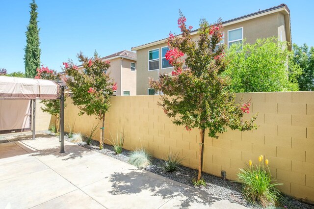 3482 Elevations Way, Clovis, CA 93619 - fenced backyard with a patio area