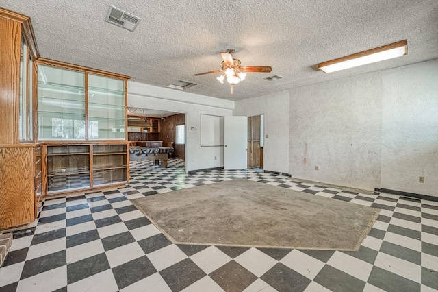 5578 E Perrin Rd, Clovis, CA 93619 - unfurnished living room with tile patterned floors, ceiling fan, and a textured ceiling