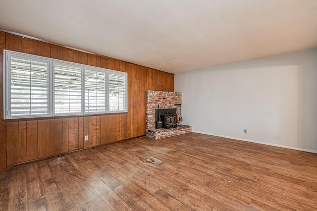 5578 E Perrin Rd, Clovis, CA 93619 - unfurnished living room with wood-type flooring and wooden walls