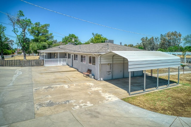 5578 E Perrin Rd, Clovis, CA 93619 - view of front of property with driveway, a detached carport, and stucco siding