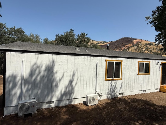 1248 Crane Ln, Yokuts Valley, CA 93675 - view of home's exterior featuring crawl space, a mountain view, and roof with shingles