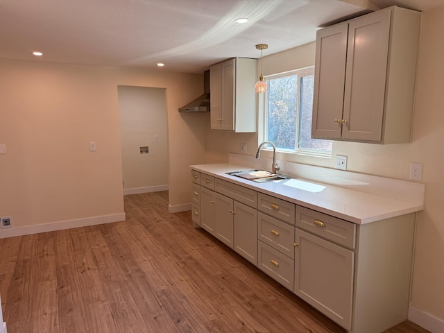 1248 Crane Ln, Yokuts Valley, CA 93675 - kitchen with wall chimney range hood, light wood-style flooring, light countertops, recessed lighting, and decorative light fixtures