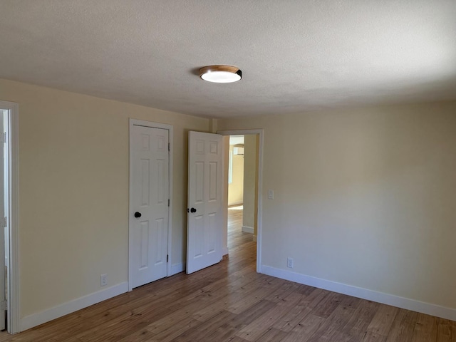 1248 Crane Ln, Yokuts Valley, CA 93675 - unfurnished room with wood finished floors and a textured ceiling