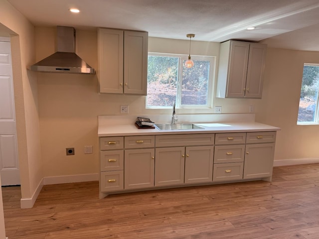 1248 Crane Ln, Yokuts Valley, CA 93675 - kitchen with wall chimney range hood, gray cabinets, recessed lighting, light wood-style floors, and light countertops
