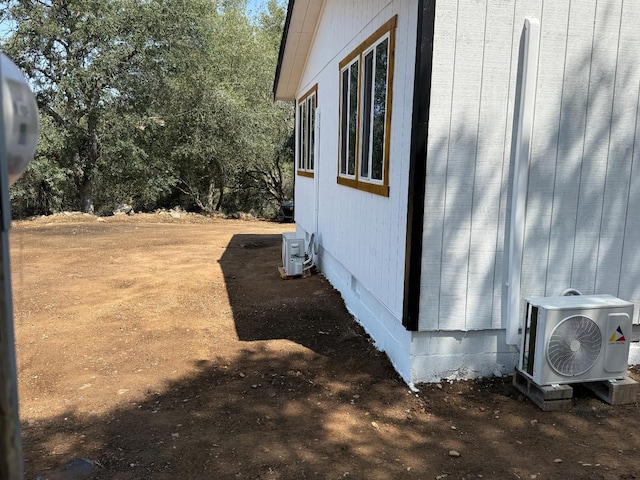 1248 Crane Ln, Yokuts Valley, CA 93675 - view of side of property with an ac unit and crawl space
