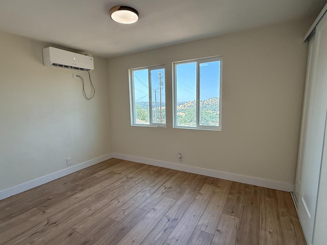 1248 Crane Ln, Yokuts Valley, CA 93675 - unfurnished room featuring a wall unit AC and wood-type flooring