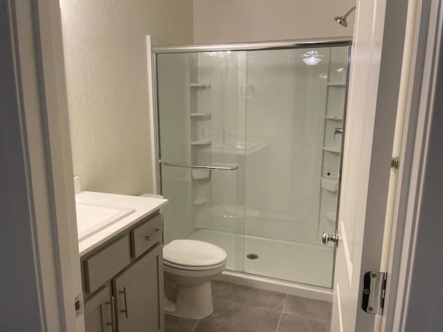 624 Suzanne Dr, Merced, CA 95348 - bathroom featuring a stall shower, vanity, tile patterned floors, and a textured wall