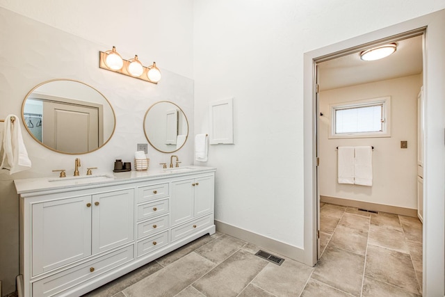 254 W Sierra Ave, Clovis, CA 93612 - full bathroom featuring double vanity and baseboards