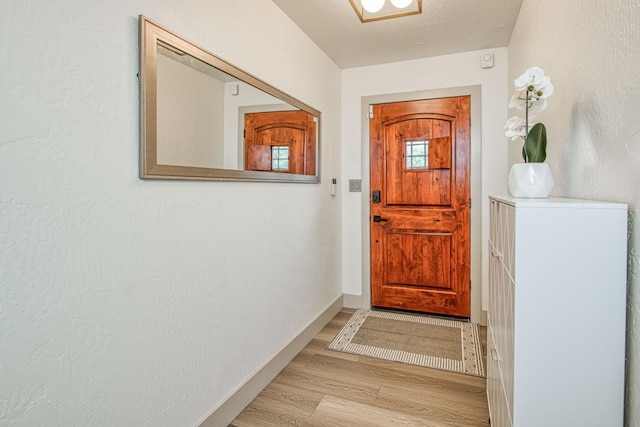 254 W Sierra Ave, Clovis, CA 93612 - doorway to outside featuring light wood-style flooring and baseboards