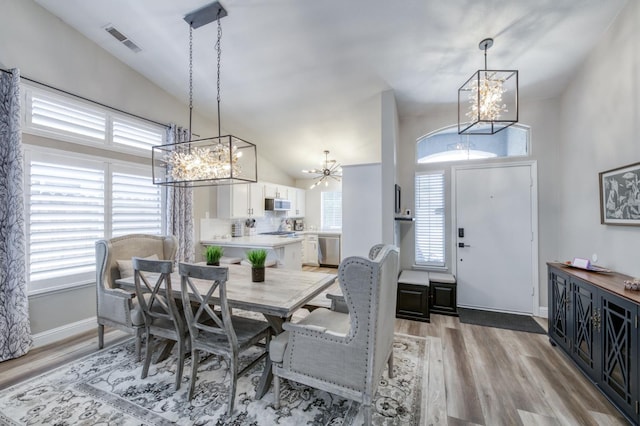 1760 E Ticonderoga Dr, Fresno, CA 93720 - dining room featuring a chandelier, lofted ceiling, and light wood-type flooring