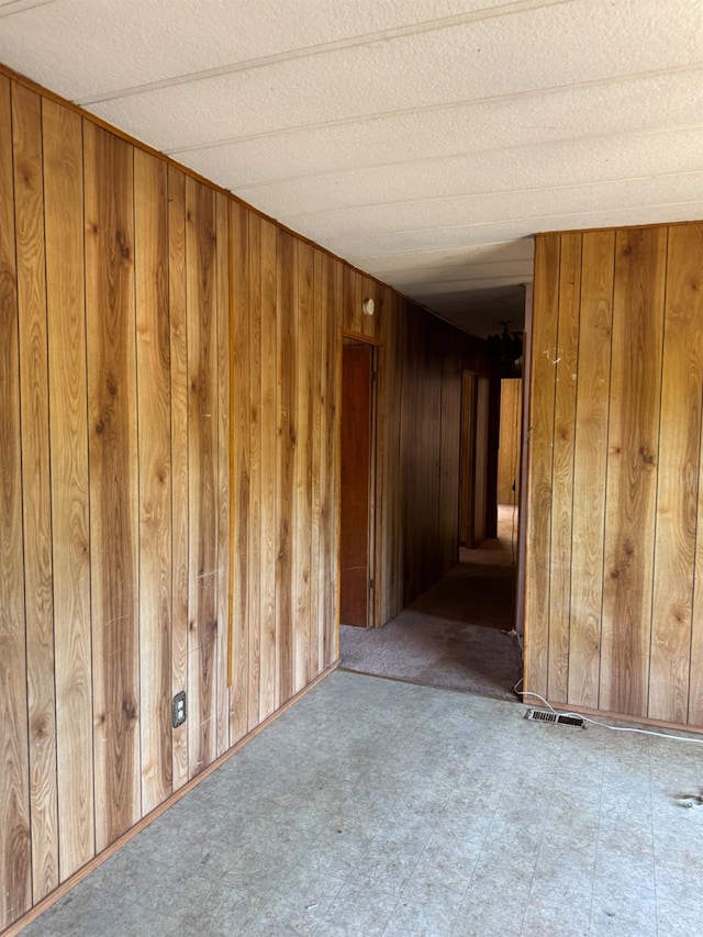 50481 Sundew Rd, Yokuts Valley, CA 93675 - unfurnished room with wood walls and tile patterned floors
