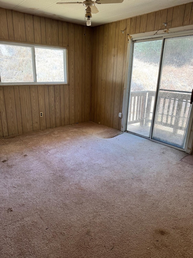 50481 Sundew Rd, Yokuts Valley, CA 93675 - spare room with ceiling fan, carpet floors, and wood walls