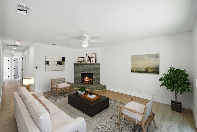 4506 N Angus St, Fresno, CA 93726 - living room with wood finished floors, a brick fireplace, and a ceiling fan