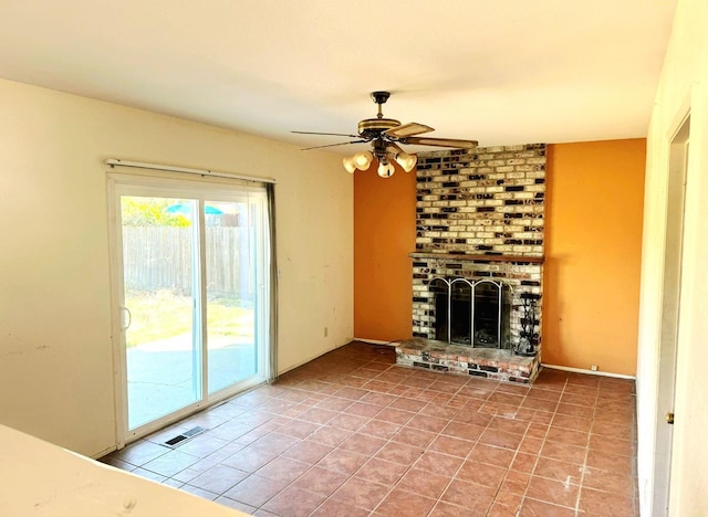 3122 Belmira Rd, Atwater, CA 95301 - unfurnished living room featuring a ceiling fan, a brick fireplace, and tile patterned flooring
