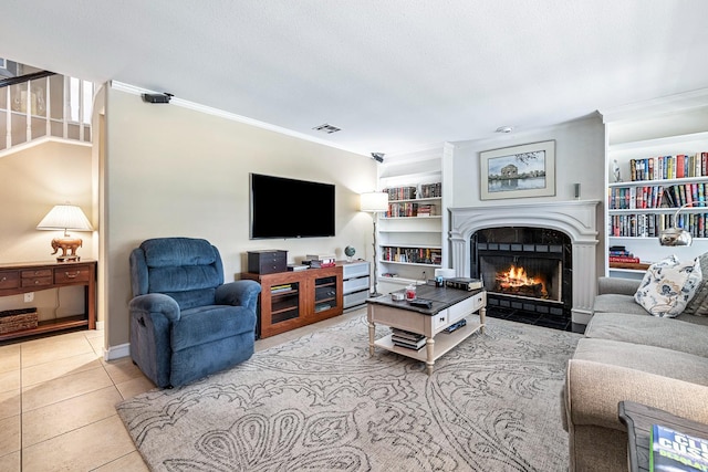 3075 W Silverhill Ln, Fresno, CA 93711 - living room with ornamental molding, a fireplace with flush hearth, light tile patterned flooring, and built in features