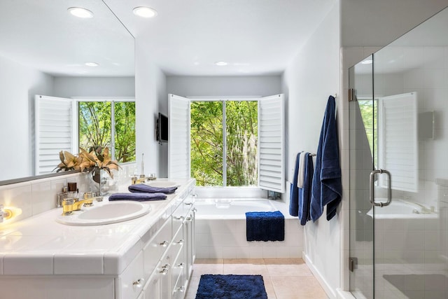 3075 W Silverhill Ln, Fresno, CA 93711 - bathroom with double vanity, a garden tub, a stall shower, tile patterned floors, and recessed lighting