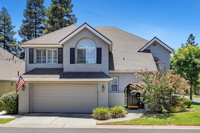 3075 W Silverhill Ln, Fresno, CA 93711 - view of front of property with stucco siding, an attached garage, and driveway