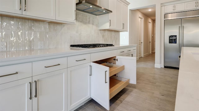 951 Talus Way S, Madera, CA 93636 - kitchen with stainless steel appliances, wall chimney range hood, light countertops, backsplash, and recessed lighting