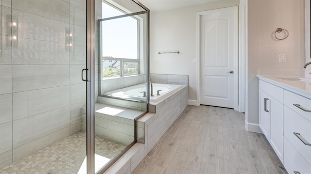 951 Talus Way S, Madera, CA 93636 - bathroom featuring vanity, a garden tub, a stall shower, and wood finished floors