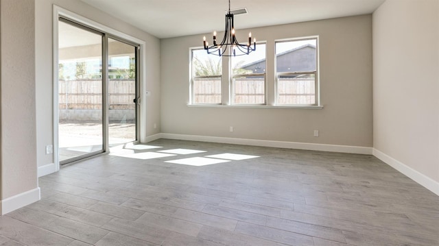 951 Talus Way S, Madera, CA 93636 - unfurnished room with a chandelier, plenty of natural light, and wood finished floors
