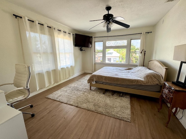 807 N Van Ness Ave, Fresno, CA 93728 - bedroom featuring wood finished floors, a textured ceiling, and a ceiling fan