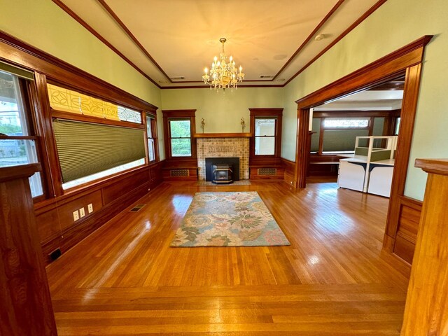 807 N Van Ness Ave, Fresno, CA 93728 - unfurnished living room with a chandelier, wainscoting, and wood finished floors