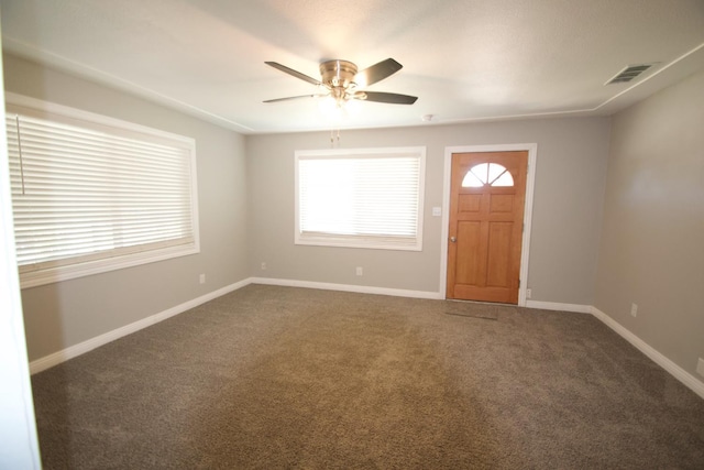 2449 S Page Ave, Fresno, CA 93725 - foyer entrance with dark carpet, a ceiling fan, and plenty of natural light