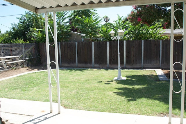 2449 S Page Ave, Fresno, CA 93725 - fenced backyard with a patio area