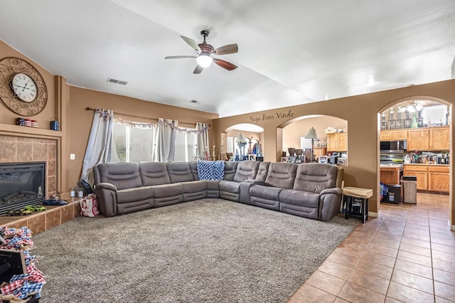 3742 Via Capitola, Madera, CA 93637 - living area with a ceiling fan, lofted ceiling, light tile patterned floors, healthy amount of natural light, and a fireplace
