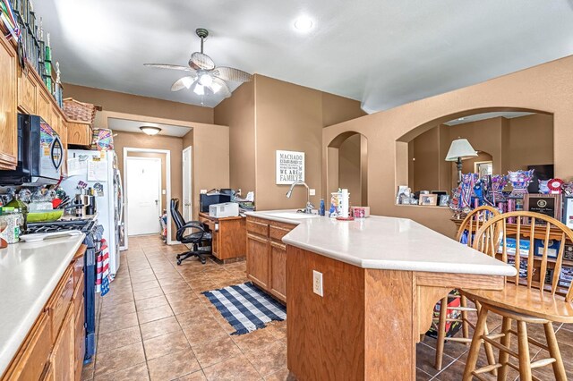 3742 Via Capitola, Madera, CA 93637 - kitchen featuring black microwave, gas range, a ceiling fan, and light countertops