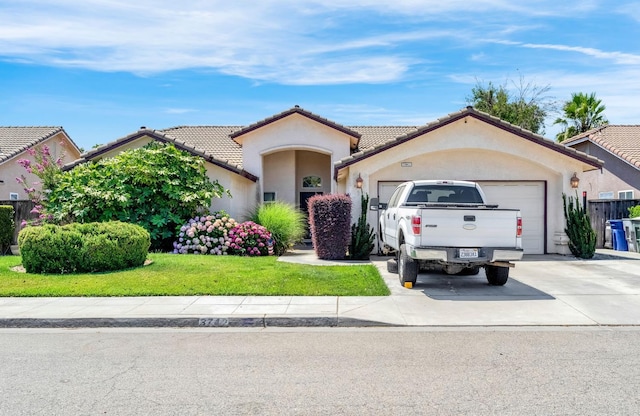 3742 Via Capitola, Madera, CA 93637 - view of front facade featuring driveway, a garage, stucco siding, a tile roof, and a front yard