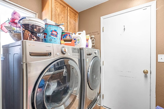 3742 Via Capitola, Madera, CA 93637 - laundry area featuring independent washer and dryer, cabinet space, and a textured wall