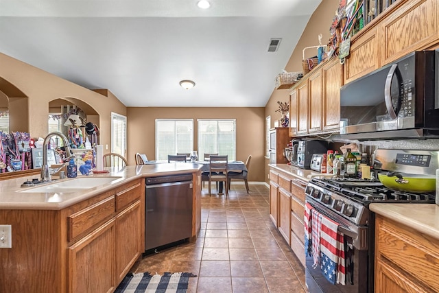 3742 Via Capitola, Madera, CA 93637 - kitchen featuring appliances with stainless steel finishes, light countertops, tile patterned flooring, and lofted ceiling