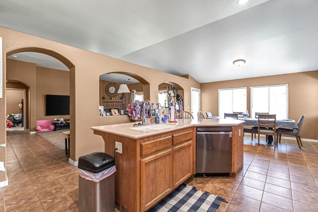 3742 Via Capitola, Madera, CA 93637 - kitchen with stainless steel dishwasher, lofted ceiling, tile patterned floors, light countertops, and a center island with sink