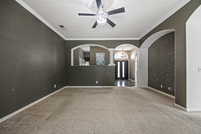 7507 N Constance Ave, Fresno, CA 93722 - unfurnished room featuring arched walkways, ceiling fan, carpet floors, and crown molding