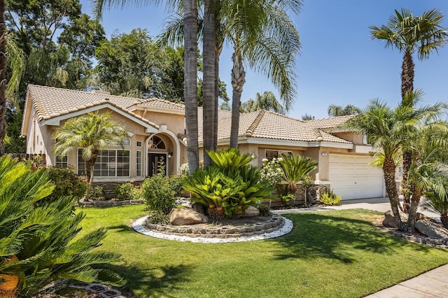 7507 N Constance Ave, Fresno, CA 93722 - mediterranean / spanish house featuring stucco siding, a tiled roof, an attached garage, and a front yard
