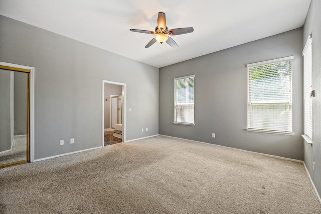 7507 N Constance Ave, Fresno, CA 93722 - unfurnished bedroom with carpet floors, ensuite bathroom, a ceiling fan, and a closet