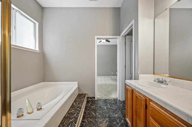 7507 N Constance Ave, Fresno, CA 93722 - full bathroom featuring marble finish flooring, vanity, and a bath