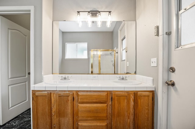 7507 N Constance Ave, Fresno, CA 93722 - bathroom featuring double vanity, a stall shower, and marble finish flooring