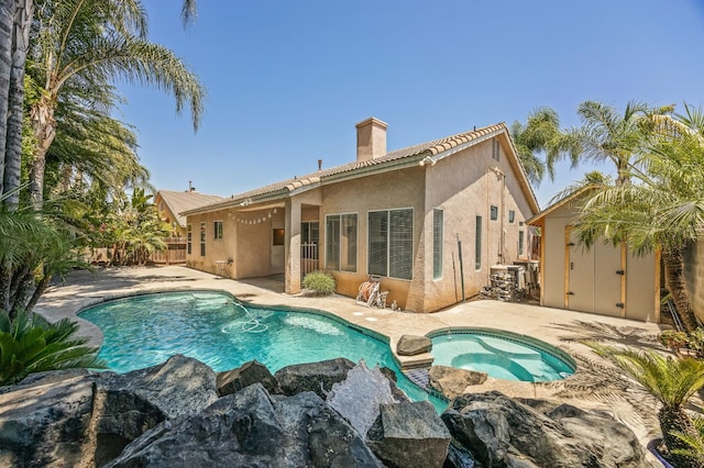 7507 N Constance Ave, Fresno, CA 93722 - view of swimming pool featuring a shed, a patio, and a pool with connected hot tub