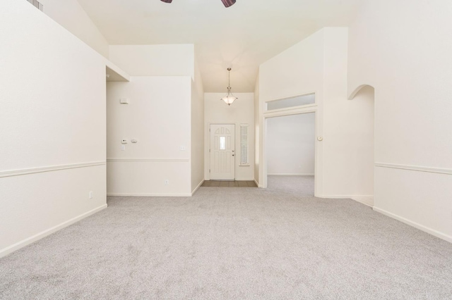 4713 W Morris Ave, Fresno, CA 93722 - spare room with ceiling fan, carpet flooring, vaulted ceiling, and arched walkways