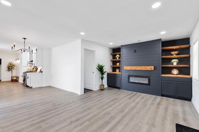 438 E Cortland Ave, Fresno, CA 93704 - bar area featuring a fireplace, light wood finished floors, recessed lighting, a chandelier, and pendant lighting